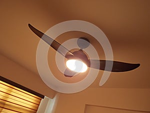 A single three-bladed ceiling direct current motor DC fan with LED lighting function