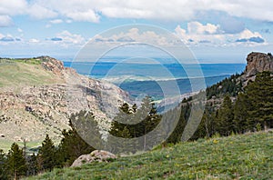 Photo taken from Sinks Canyon State Park in Lander, Wyoming. See the valley plains below with blue sky cloud beauty.