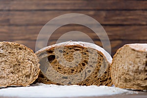 Photo of tasty fresh bread loaves on the wonderful brown wooden
