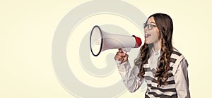 photo of teen girl announcer with megaphone, advertisement. teen girl announcer