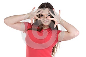 Photo of teenage girl with hands near face