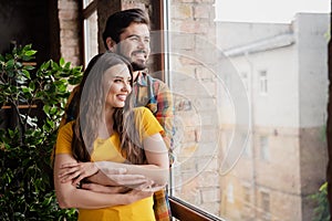 Photo of tender peaceful couple cuddle hug look window harmony time wear casual clothes home indoors