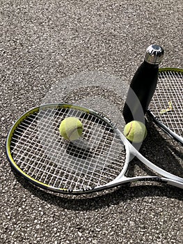 Photo of tennis ball, racket and water bottle
