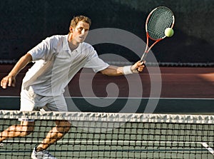 Tennis Player Swinging at Ball