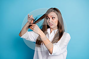 Photo of terrified hairdresser lady change style hold scissors cut down split ends wear white shirt isolated blue color