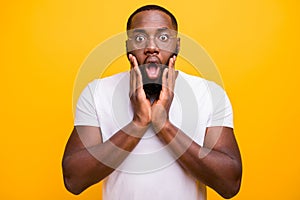 Photo of terrified shocked black man having been negatively surprised while isolated with vivid background