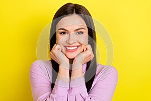 Photo of think brown hairdo milennial lady hands cheeks wear purple shirt isolated on yellow color background