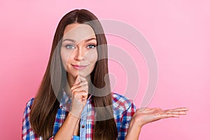 Photo of thought brunette millennial lady hold empty space wear blue red shirt isolated on pastel pink color background