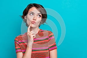 Photo of thoughtful minded woman dressed striped t-shirt thoughtfully look at promo empty space isolated on turquoise