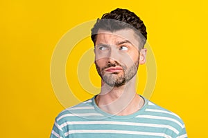 Photo of thoughtful serious man stylish haircut dressed striped t-shirt look empty space furrowed brow isolated on