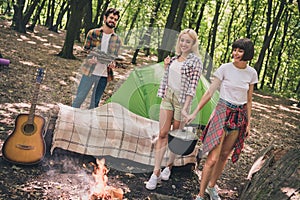 Photo of three busy friends prepare campfire meal carry supplies wear casual outfit nature woods outdoors