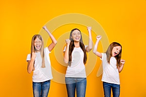 Photo of three different age ladies celebrating best win wear casual white t-shirts isolated yellow background