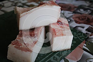 Close-up of three pieces of lard on the kitchen table