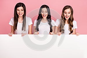Photo of three young girls happy positive smile look poster banner billboard advert excited isolated over pastel color
