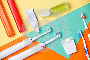 Photo of toothbrushes, tubes of pastes, floss