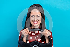 Photo of toothy beaming woman with straight hairdo dressed dotted shirt hold steering wheel buy new car isolated on blue