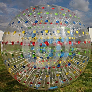 Photo transparent ball-Jogging - Zorba with multi-colored radial lines on the background of blue sky.