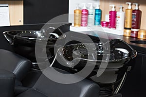 Photo of two black ceramical hair sinks standing in beaty salon.