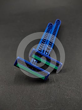 Two blue shavers isolated on a black