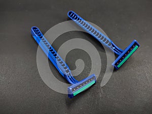 Two blue shavers isolated on a black