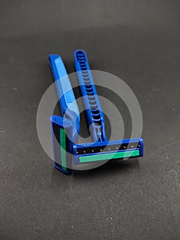 Two blue shavers isolated on a black