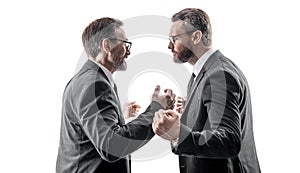photo of two businessmen fighting with anger. two fighting businessmen isolated on white