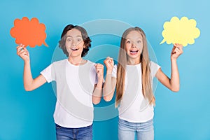 Photo of two champion kids hold mind clouds raise fist wear white t-shirt isolated blue color background