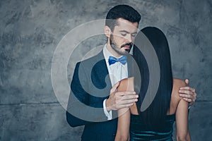 Photo of two classy people stylish trendy couple guy hiding his lady standing close tender holding her naked shoulders