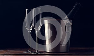 Photo of two empty wine glasses, bottle of champagne