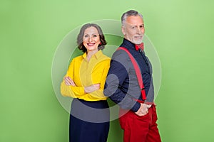 Photo of two friendly successful people folded arms pockets look camera isolated on green color background