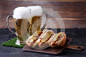 Photo of two glasses of beer, hot dogs, soccer ball