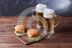 Photo of two hamburgers, glasses with beer