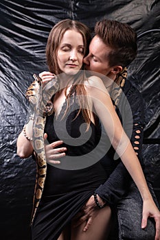 Photo of two kissing lesbian women with snakes