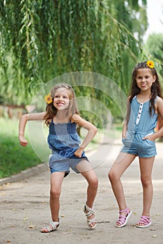 Photo of two little girls in summer park