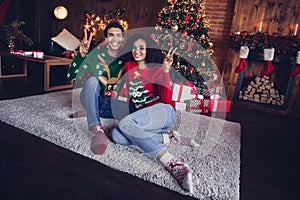 Photo of two lovers guy lady sitting floor in comfort cozy apartment indoors make selfie on christmas event occasion