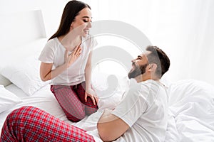 Photo of two people best friends have talk laughing sit bed in white light house