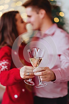 Photo of two people holding glasses of shampagne on xmas