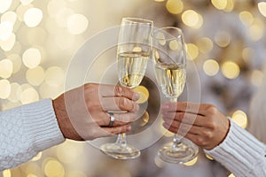 Photo of two people holding glasses of shampagne on xmas