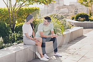 Photo of two people sit have conversation guy flirt woman wear casual clothes in garden park outdoors