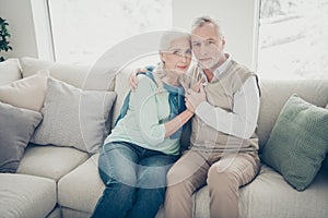 Photo of two pretty aged people pair leaning heads family portrait sitting cozy sofa indoors