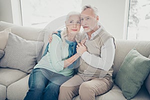 Photo of two pretty aged people pair leaning heads family portrait sitting cozy sofa indoors