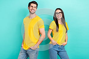 Photo of two teammates partners yellow t-shirts denim jeans hands pockets stylish ray ban glasses good job isolated on