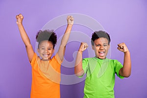 Photo of two young little african kids happy positive smile rejoice winner success isolated over violet color background