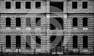 Photo of unfinished brown building with many windows, black and white