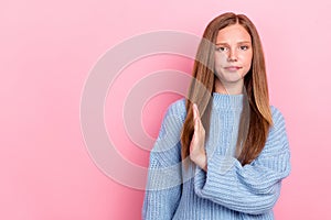 Photo of unhappy dissatisfied schoolgirl teenager wear blue sweater showing no symbol palm empty space taboo kisses