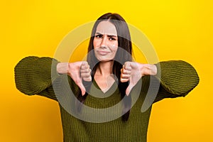 Photo of unsatisfied person arms fingers demonstrate thumb down isolated on yellow color background