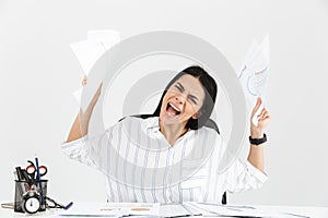 Photo of uptight brunette businesswoman 30s screaming and stressing while working with paper documents in office