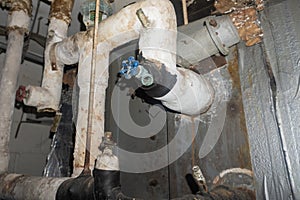 Valve on elbow of asbestos insulated pipe photo