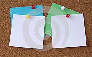 Photo of various colorful papers with space for text pinned with colorful pins on a note board