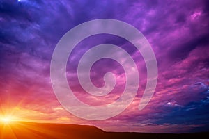 Photo of a violet sunset with clouds